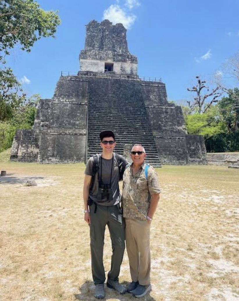 Kapu Alan Akana standing in front of Tikal and Yaxha in Guatemala